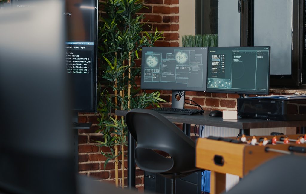 desk-with-multiple-computer-monitors-displaying-ne-PMBWC2A.jpg